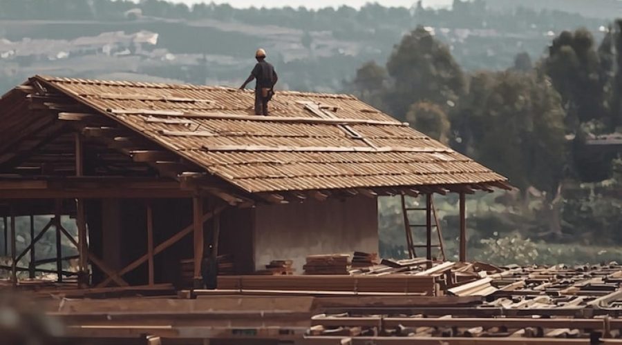 worker-placing-roof-house-capturing-construction-process-ar-169_995029-1666